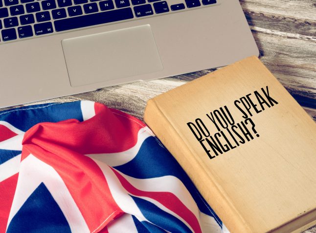 A computer, flag of Great Britain and book titled Speak English
