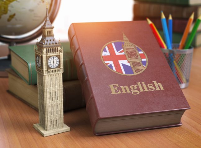 Studying and learn English concept. Book with flag of Great Britain and Big Ben tower on the table. 3d Iluustration