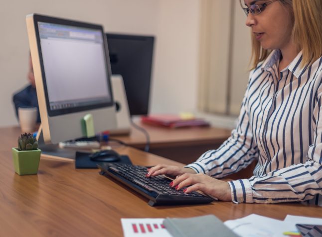 Businesswoman working on computer at workplace, using keyboard, typing, business concept, leader.